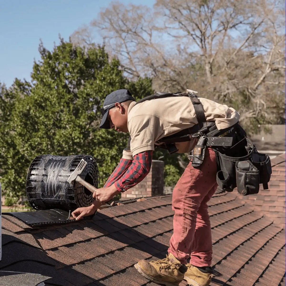 Roofer installing a ridge vent