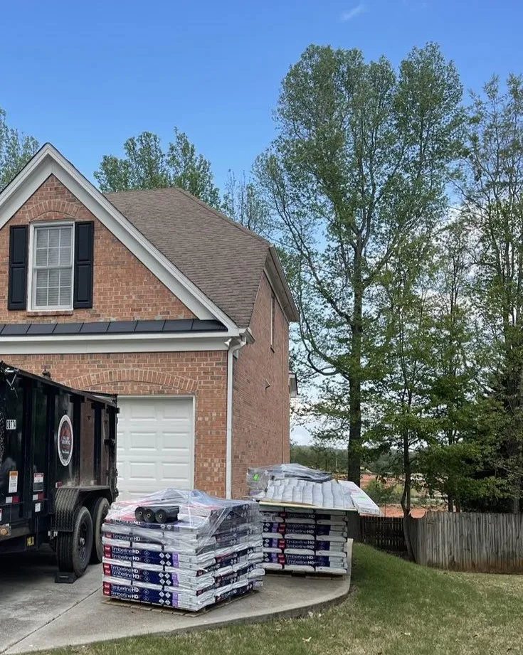 Staged for install day — Shingle pallets loaded before the crew arrives