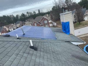 North Port Roofing experts from Hill Top Roofing inspecting a roof after a hurricane.